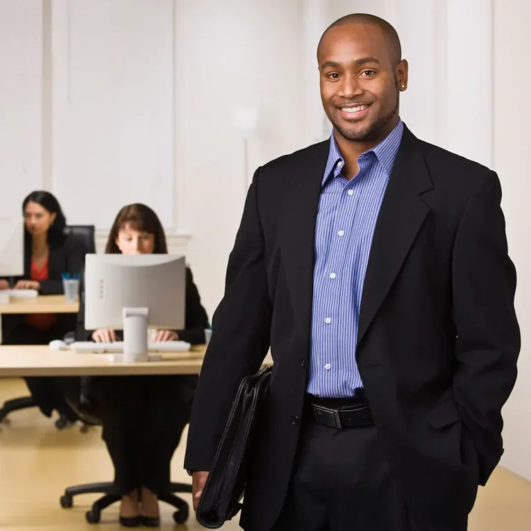 66512766_man-in-office-smiling-at-camera